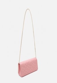 Quilted pink clutch bag with a geometric pattern, featuring a gold chain strap for carrying. Rectangular shape with a smooth texture.
