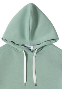Sweat à capuche vert clair avec cordons blancs et une étiquette de marque "CECIL" visible à l'intérieur du col de la capuche.