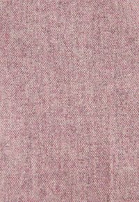 Textilstoff in hellrosa mit einer subtilen Textur und gewebtem Muster, das verschiedene Farbtöne aufweist, die Tiefe und Interesse verleihen.