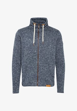 Marineblauwe rits-hoodie van textuur-gebreid stof met crèmekleurige trekkoorden, frontzakken en een bruine leren logo patch aan de zoom.