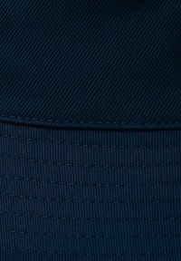 Navy blue textile featuring a diagonal ribbed pattern at the top and horizontal stripes at the bottom, with visible stitching details.