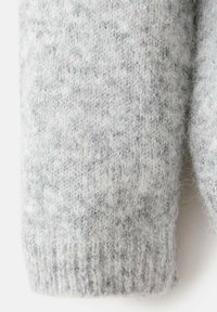 Sivi pleteni rukav džempera s teksturiranim uzorkom, rebrastim manžetama i mekanim, dlačicama materijalom. Suptilne varijacije u sivim tonovima.