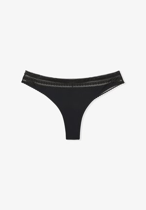Black women's thong underwear with a sheer lace waistband and scalloped edges, displayed on a white background.