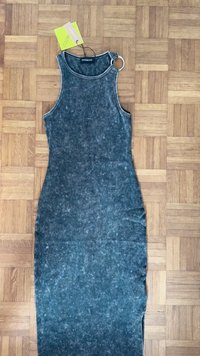 Ermeløs denimkjole i mørkeblått med falmet tekstur. Har rund halsringning og en sølvringdetalj på skulderstroppen.
