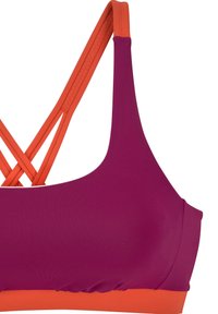 Violetinio sportinio liemens su oranžiniais akcentais. Yra kryžminiai dirželiai ir lygus paviršius. Sukurtas komfortui ir palaikymui.