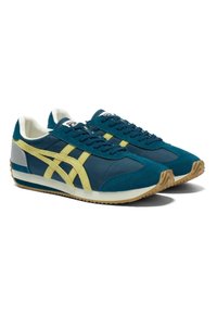 Teal suede and nylon sneakers with yellow stripes, white accents, and a gum rubber sole. Classic design with lace-up closure and round toe.