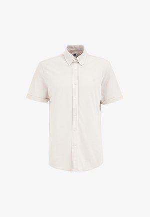 Lühikeste varrukatega nööbiga särk heledast beežist puuvillast, millel on klassikaline krae ja väike logo broderi vasakul rinnal.