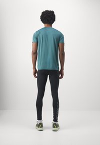 New Balance SLEEK REFLECIVE TIGHT - Leggings - black