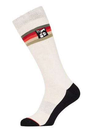 Kniehoge sokken in beige met een geribde manchet. Heeft een gestreept patroon in rood, groen en zwart. Zwarte accenten bij de teen en hiel.