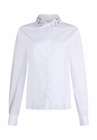 Chemise blanche à manches longues avec devant boutonné et col décoratif orné de perles délicates et de motifs floraux. Matière en coton, texture lisse.