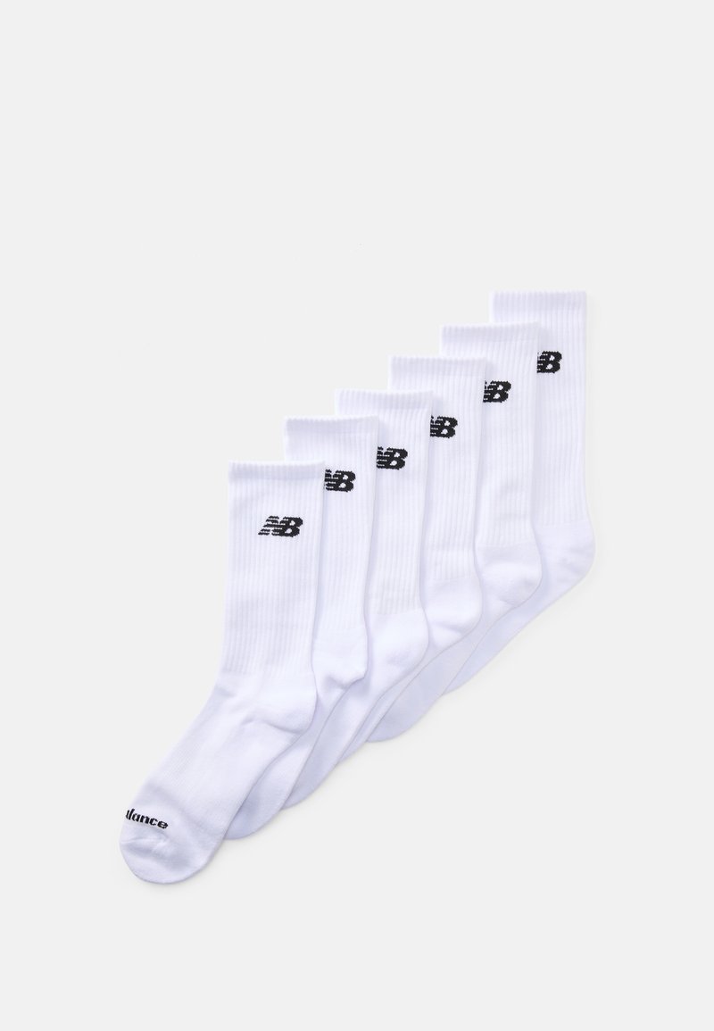 White athletic socks, featuring ribbed texture, a black New Balance logo, and a black "NB" at the ankle, arranged in a row. Six pairs total.