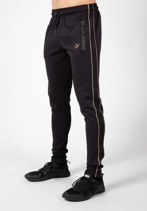WENDEN - Tracksuit bottoms - gold-coloured