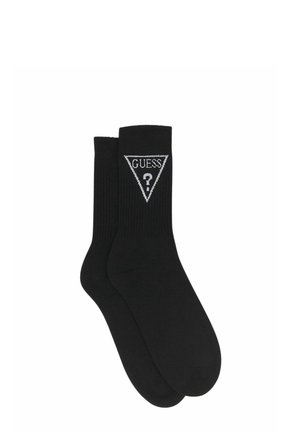 Calzini neri in cotone con una trama a coste e un logo triangolare bianco con la scritta "GUESS" e un punto interrogativo.