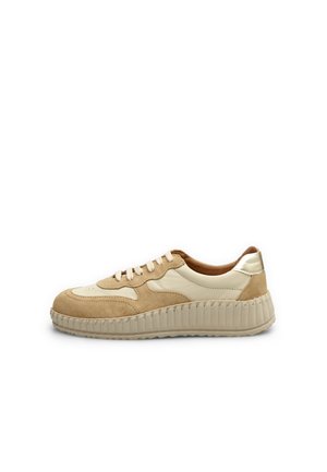 Sneaker featuring beige suede and cream leather, round toe, lace-up design, and a thick textured sole with a metallic heel accent.