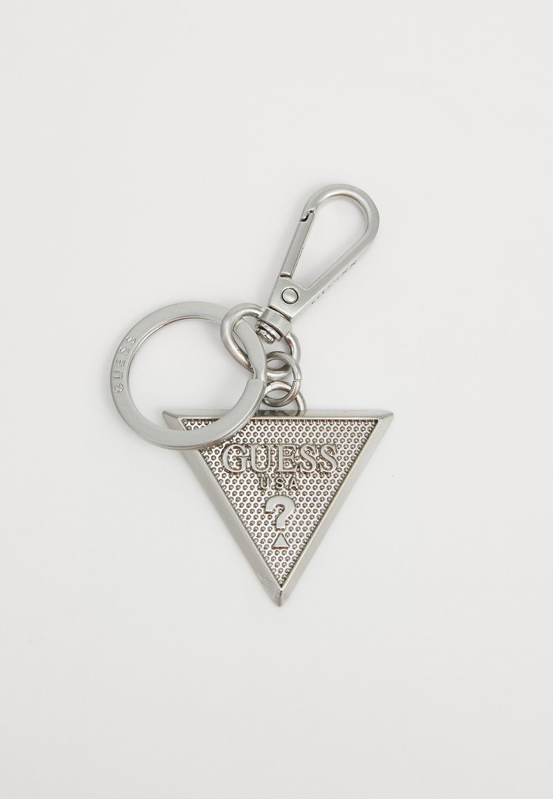 Silver triangular keychain featuring "GUESS" embossed, textured surface, attached to a metal clip and keyring for easy attachment.