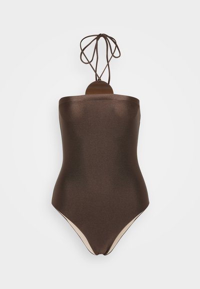 Brown, strapless one-piece swimsuit with a smooth, shiny texture. Features a halter tie at the back and contrasting light beige accents at the legs.