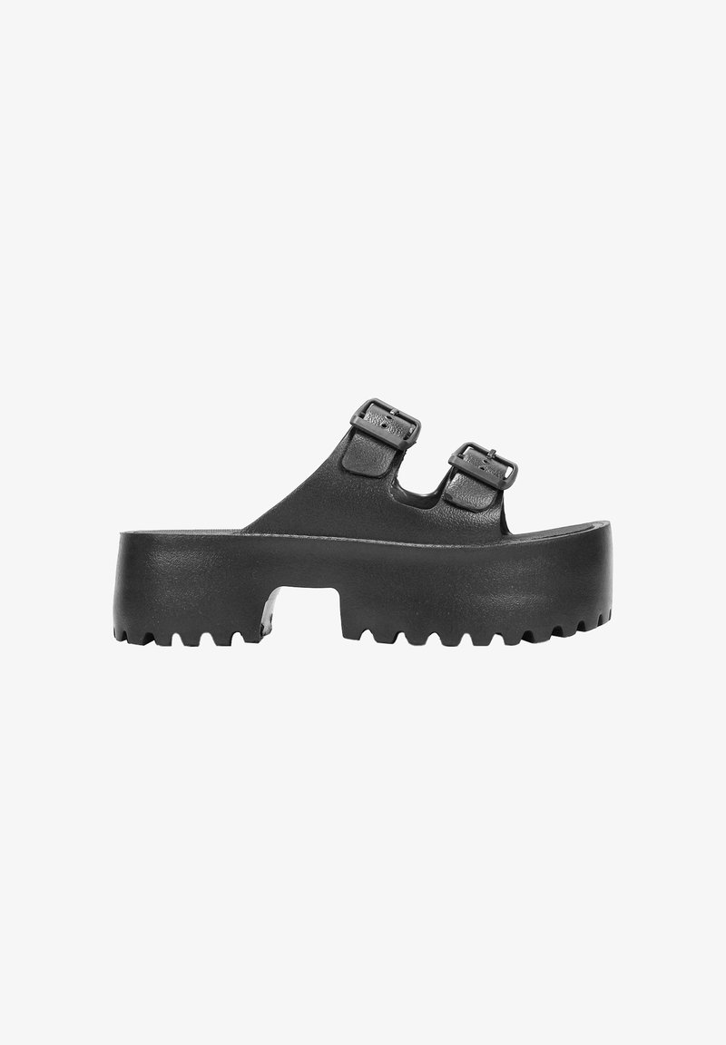 Black platform sandals featuring two adjustable buckle straps. Made of a smooth material with a textured, ridged sole for grip.