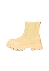 Stivaletti in suede beige con pannelli laterali elastici, bordo in pelliccia al colletto e suole in gomma spessa caratterizzate da un battistrada evidente.