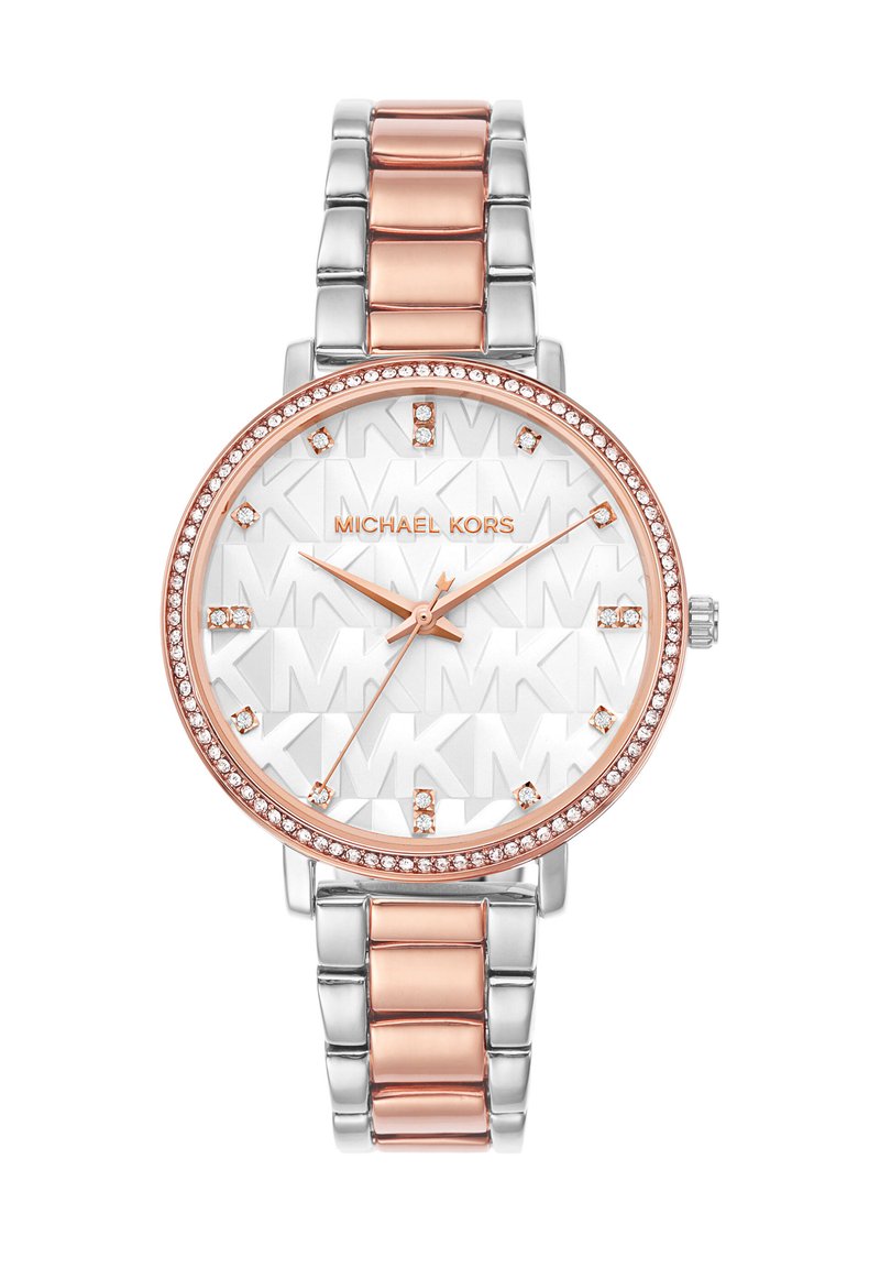 Sølv- og rosaguldur med et rundt urskive, tekstureret hvid skive, krystalaccenter og et to-tonet metalarmbånd. Har minimalistiske timemarkører.