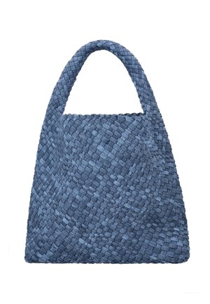 Modrá tkaná kabelka s jedním širokým uchem, lichoběžníkového tvaru a texturovaným proplétaným vzorem tkaniny, vyfocená na bílém pozadí.
