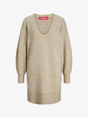 Beež oversized V-kaelusega kampsun, millel on pikad, kitsenevad varrukad, soonikserv ja peen tekstuur. Sildil on roosa märk "JJXX."