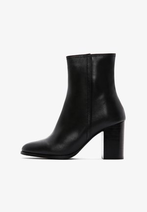 Zwarte leren enkelboot met een spitse neus en een chunky vierkante hak. Kenmerkt zich door een gladde textuur en minimale stikdetails.