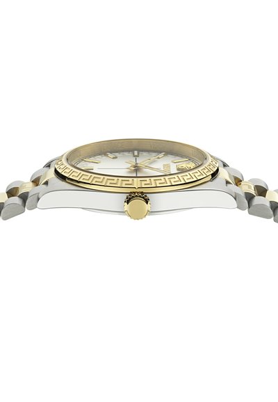 Divkrāsu pulkstenis ar nerūsējošā tērauda un zelta toņa korpusu, sudraba ciparnīcu, Grieķu atslēgas raksta rāmīti un zelta kroni sānos.