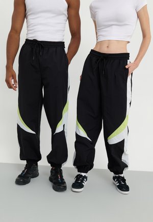 YOURTURN by Zalando UNISEX - Tracksuit bottoms - black