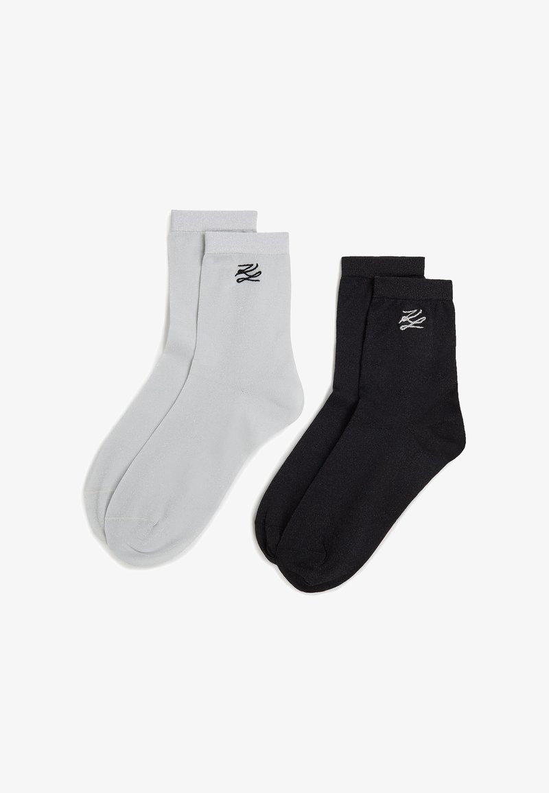 Melnas un pelēkas kokvilnas zeķes ar ribotām atlokām, katrā zeķē ir neliels melns logs. Gluda tekstūra, standarta garuma crew zeķes.