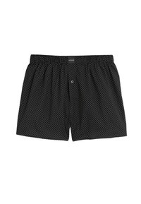 Boxers negros hechos de tela suave con lunares blancos, una cintura elástica y un cierre de botón en la parte delantera.