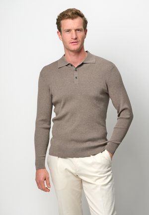 Brown ribbed knit polo sweater with a collared neckline, featuring three buttons and long sleeves, paired with light-colored trousers.