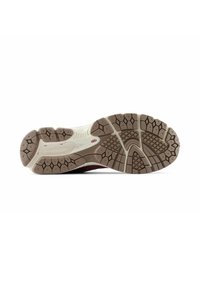 Brown rubber outsole with textured tread patterns. Cream midsole with a slight curve. Accented with red detail near the heel.