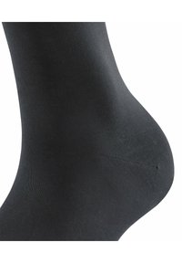 Schwarze Knöchelsocke aus glattem, elastischem Stoff, mit einem nahtlosen Design und einem dezenten Glanz sowie verstärkten Nähten an der Ferse.