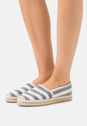 Espadrilles featuring a white fabric upper with navy diagonal stripes, jute rope sole, and a round toe design.