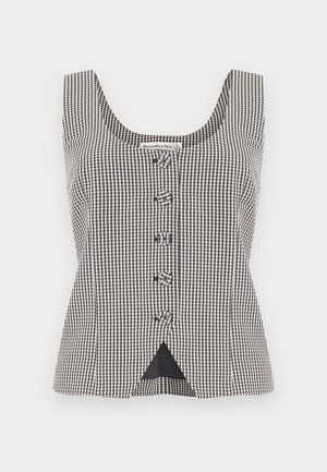 Blouse sans manches à carreaux noirs et blancs avec cinq boutons au centre et une petite fente triangulaire à l'avant, au niveau de l'ourlet.