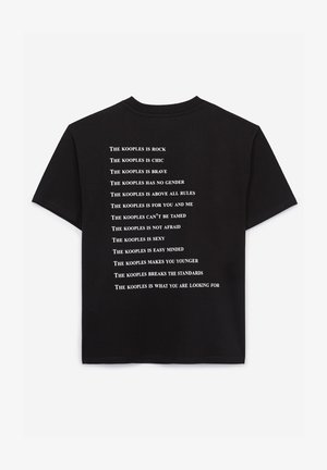 Black cotton t-shirt featuring white printed text listing phrases from "The Kooples" along the back. Short sleeves and relaxed fit.