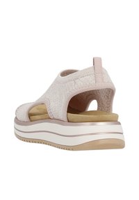 Pink knitted sandal with open back, padded insole, and layered white sole. Features elastic bands for a secure fit and textured surface.