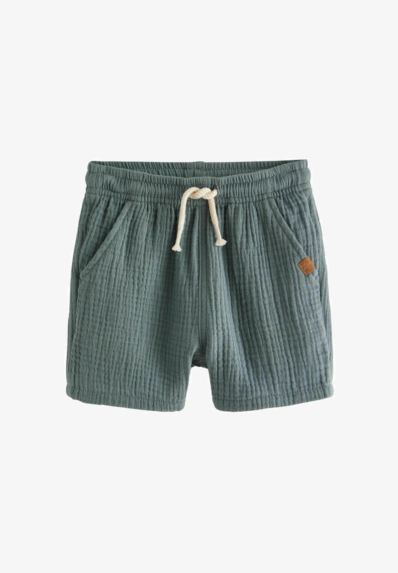 Cotton blend shorts in muted green, featuring a ribbed texture, elastic waistband, drawstring closure, and side pockets. Leather logo patch detail.