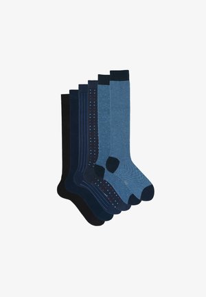 Set di sei calzini in tonalità blu e navy. Le caratteristiche includono motivi a coste, pois e disegni a righe. Texture e lunghezze variabili.