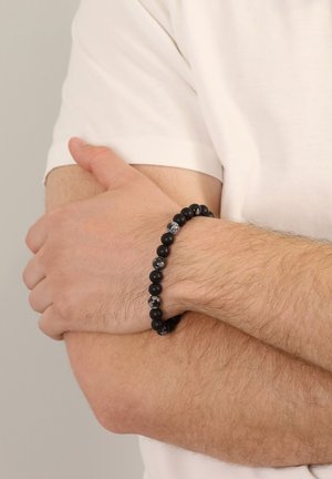 Black beaded bracelet featuring matte black and speckled gray beads, showcasing a round shape and a smooth texture.