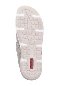 Beige footwear with a textured rubber sole featuring grooves and patterns. The brand name "rieker" is marked in red near the heel.