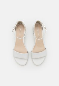 Sandales blanches pour femmes avec brides à la cheville et boucles, orteils ouverts, semelles plates et marquage « Tamaris » à l'intérieur, taille 37.