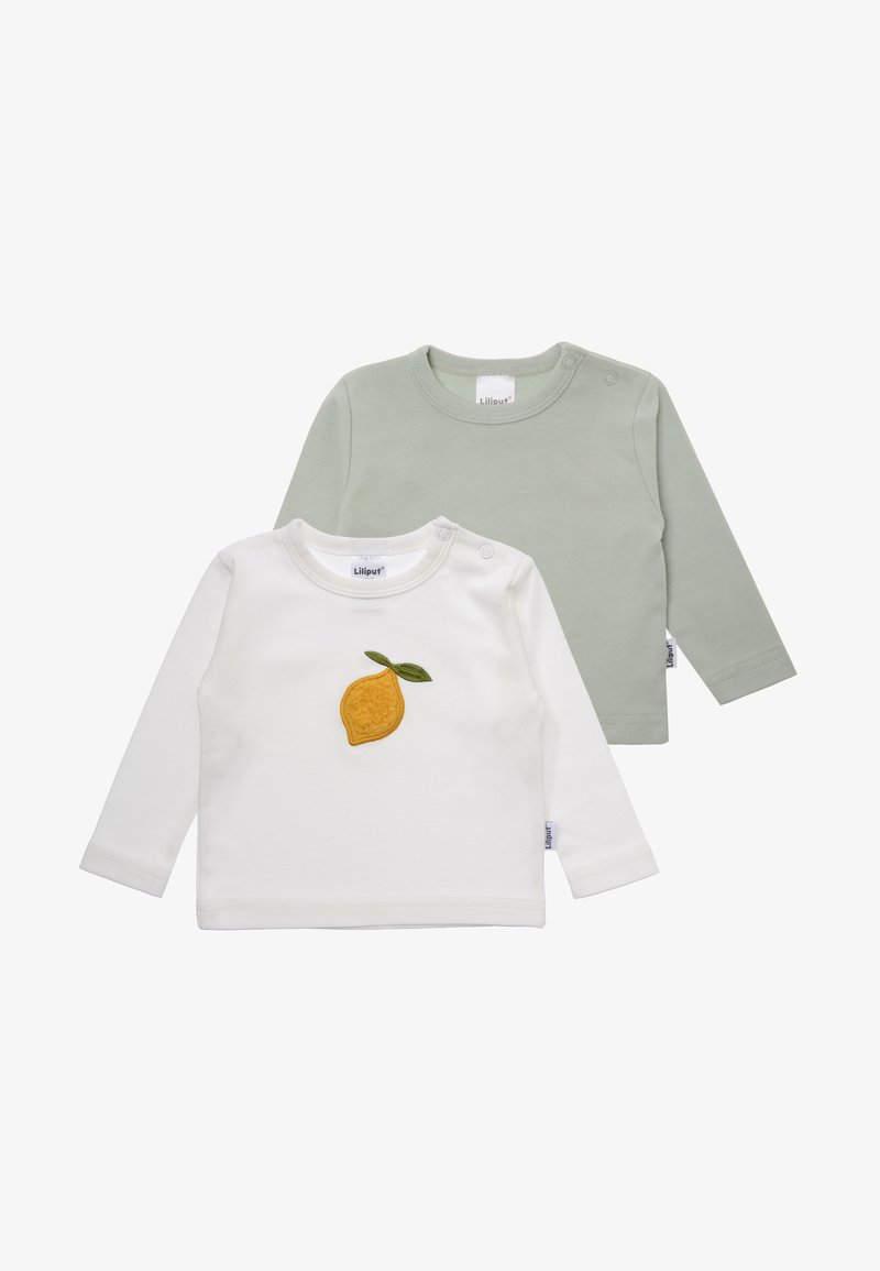 Two long-sleeve baby shirts: one white with yellow lemon embroidery and green leaf, the other solid pale green, both in soft fabric.