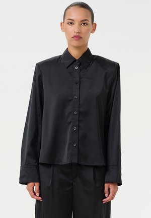Black satin shirt with a pointed collar, long sleeves, and button-down front. Features a relaxed fit and smooth texture.