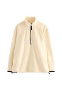 Krémový fleecový pulovr s černým polovičním zipem a vysokým límcem, s nastavitelnými šňůrkami na spodním lemu a černými manžetami rukávů.