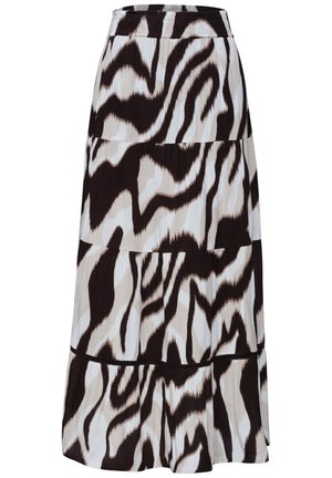 Nahaufnahme einer Person, die einen plissierten Rock mit schwarz-weiß-beigem abstraktem zebramusterähnlichen Druck trägt, Hand lässig in der Tasche, weißes Top.