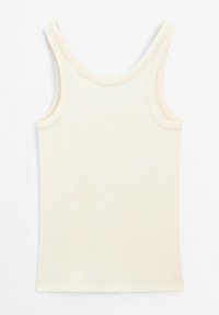 Top senza maniche color crema in cotone, con design aderente, texture liscia e scollo rotondo con dettagli di cucitura minimali.