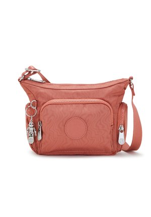 Petit sac bandoulière rose avec plusieurs compartiments zippés et un porte-clés en métal sur le côté.