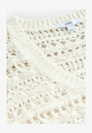 Gilet blanc en tricot présentant un motif en open weave, des bords côtelés et une étiquette indiquant la marque "NEXT". Fini doux et texturé.
