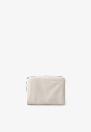 Small light beige leather zippered pouch with subtle embossed brand logo on the front, isolated on a white background.